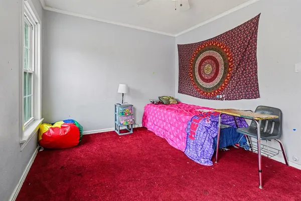 a bedroom with a bed and a dresser in it