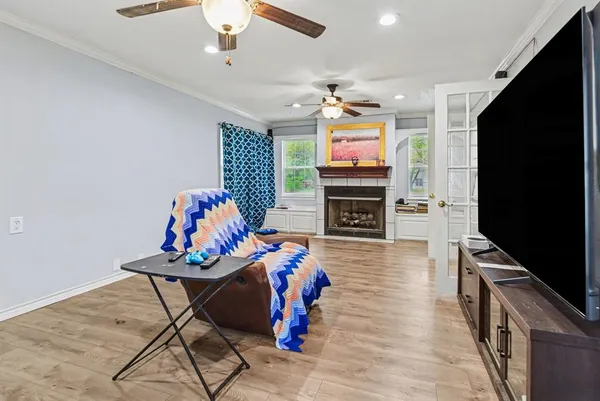 a living room with furniture a flat screen tv and a fireplace