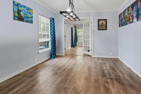 wooden floor in an empty room with a window