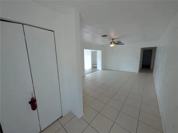 a kitchen with granite countertop a refrigerator a stove a microwave and cabinets
