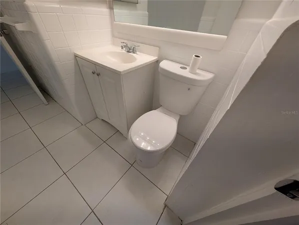 a bathroom with a sink and mirror in it