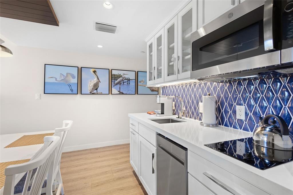 240 Sands Point Road, Unit 4104 Longboat Key, FL 34228 - Photo 16 of 47 a kitchen with a sink and cabinets
