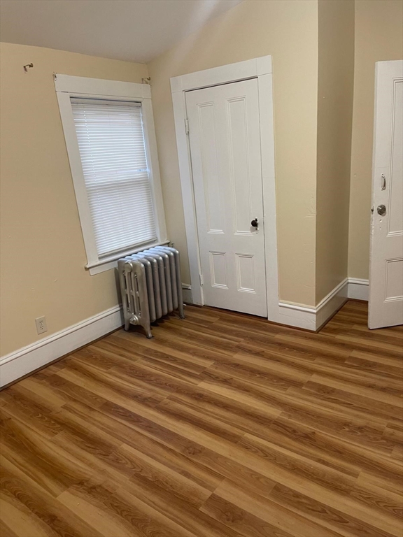 39 Magnolia Street, Unit 2 Malden, MA 02148 - Photo 11 of 15 a bedroom with a bed and wooden floor