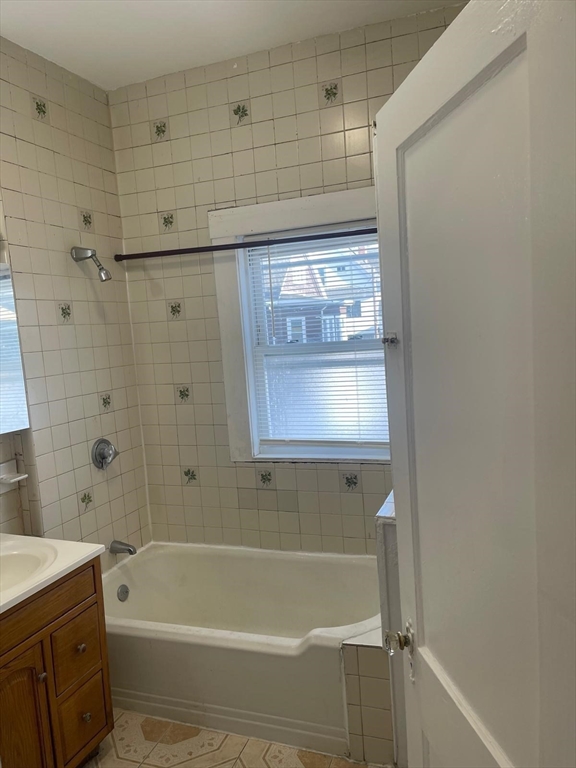 39 Magnolia Street, Unit 2 Malden, MA 02148 - Photo 3 of 15 a bathroom with a shower and a bath tub