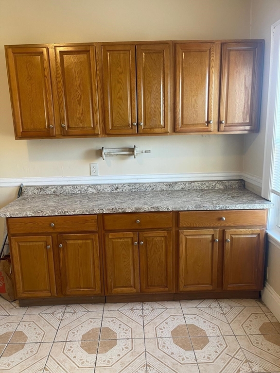 39 Magnolia Street, Unit 2 Malden, MA 02148 - Photo 6 of 15 a kitchen with granite countertop cabinets and black stainless steel appliances
