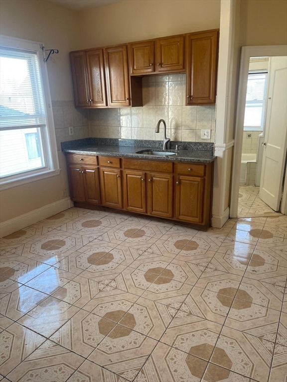 39 Magnolia Street, Unit 2 Malden, MA 02148 - Photo 8 of 15 a kitchen with stainless steel appliances a sink a stove a microwave a counter top space and cabinets