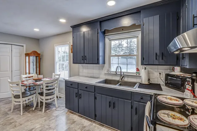 a kitchen with a sink stove and cabinets