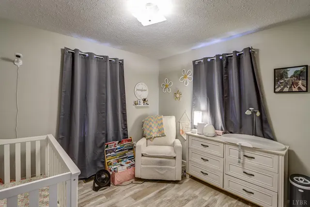 a bedroom with furniture and a mirror