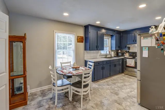 a kitchen with a table and chairs in it