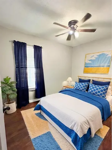 a bedroom with a large bed and a window