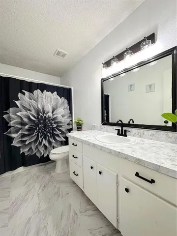 a view of a bathroom with mirror and vanity