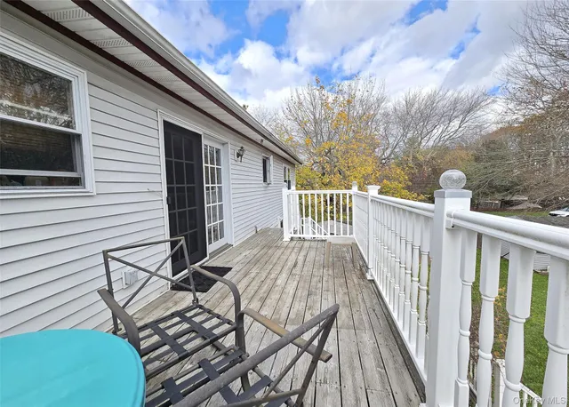 a view of a wooden deck and a backyard