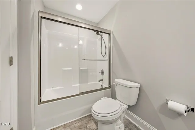 a white toilet sitting next to a bathroom sink