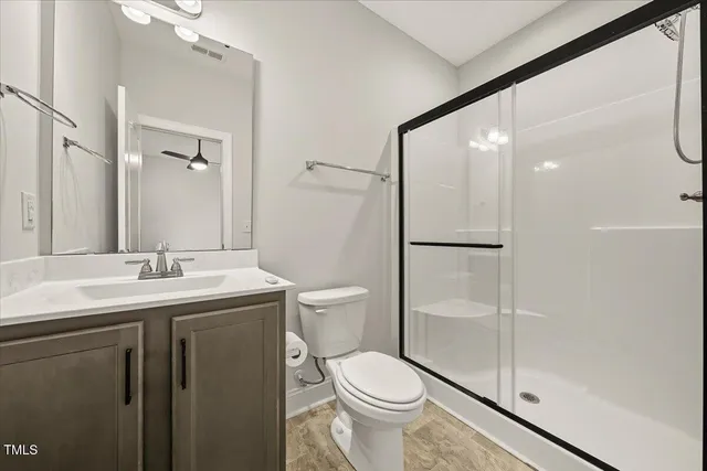 a bathroom with a toilet a sink and shower