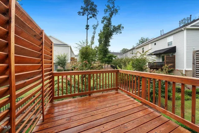 a view of balcony with wooden floor and fence