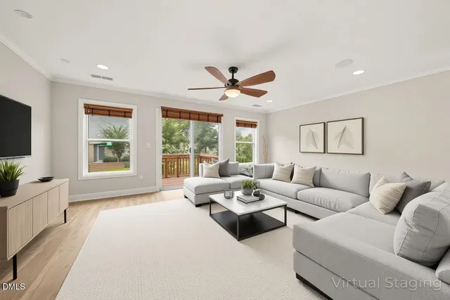 a living room with furniture large window and flat screen tv