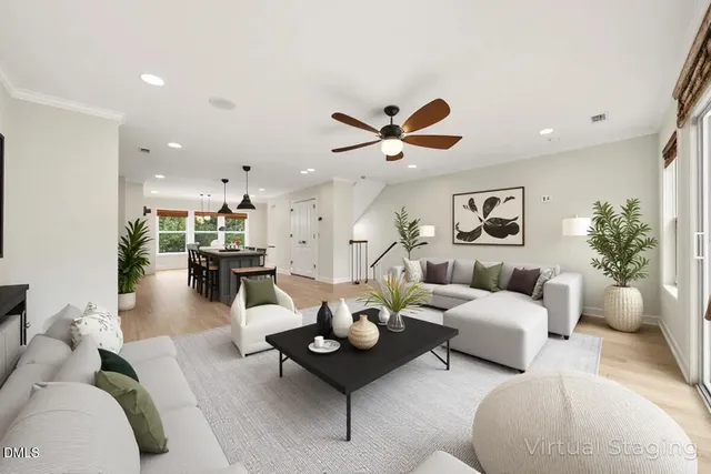 a living room with furniture and view of kitchen