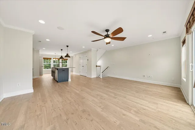 a view of a big room with wooden floor and a ceiling fan