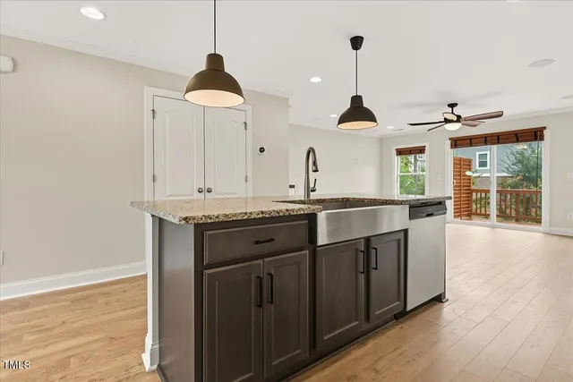 a kitchen with a sink and a chandelier