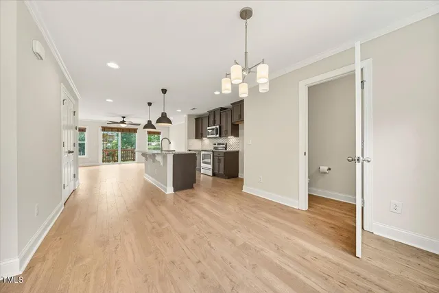 a view of a kitchen with wooden floor and a kitchen