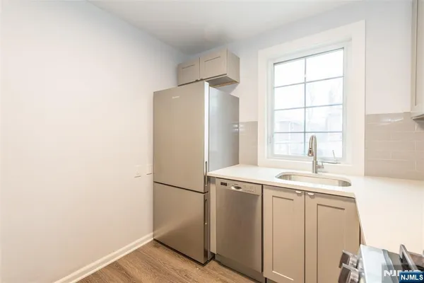 a utility room with wooden floor washer and dryer