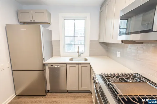 a kitchen with a refrigerator and a sink