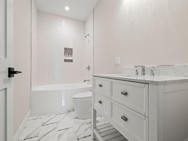 a bathroom with a sink toilet a shower and bathtub