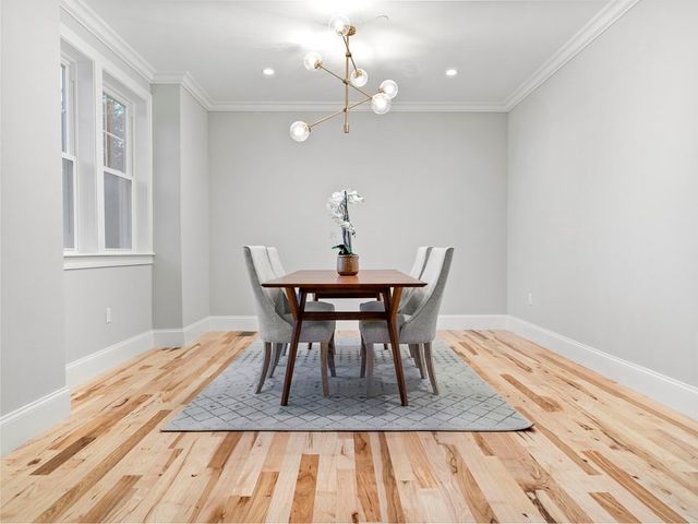 a view of a dining room with a table and chairs