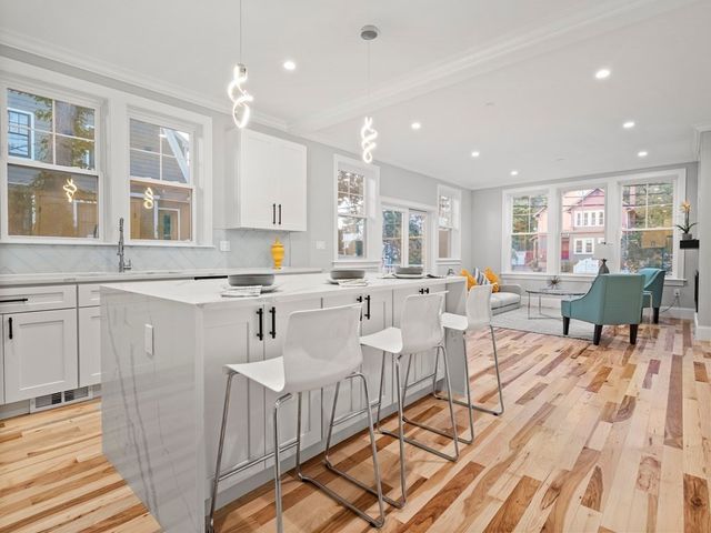 a living room with furniture and kitchen view