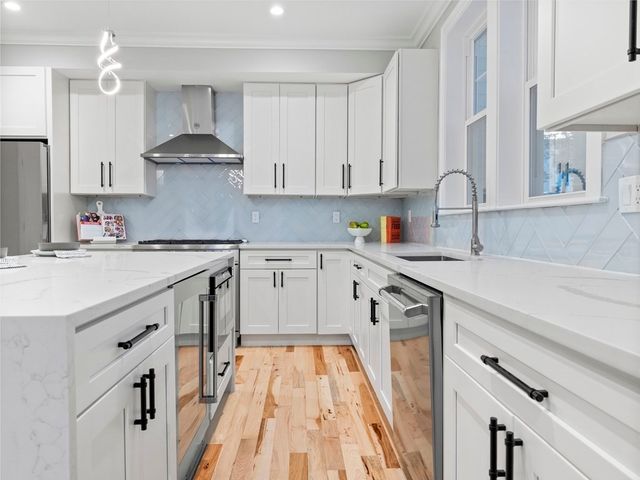 a kitchen with a sink a stove and cabinets