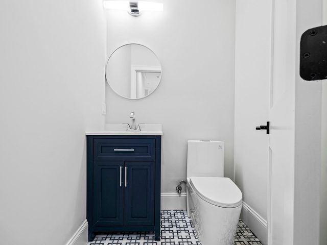 a bathroom with a toilet a sink and a mirror