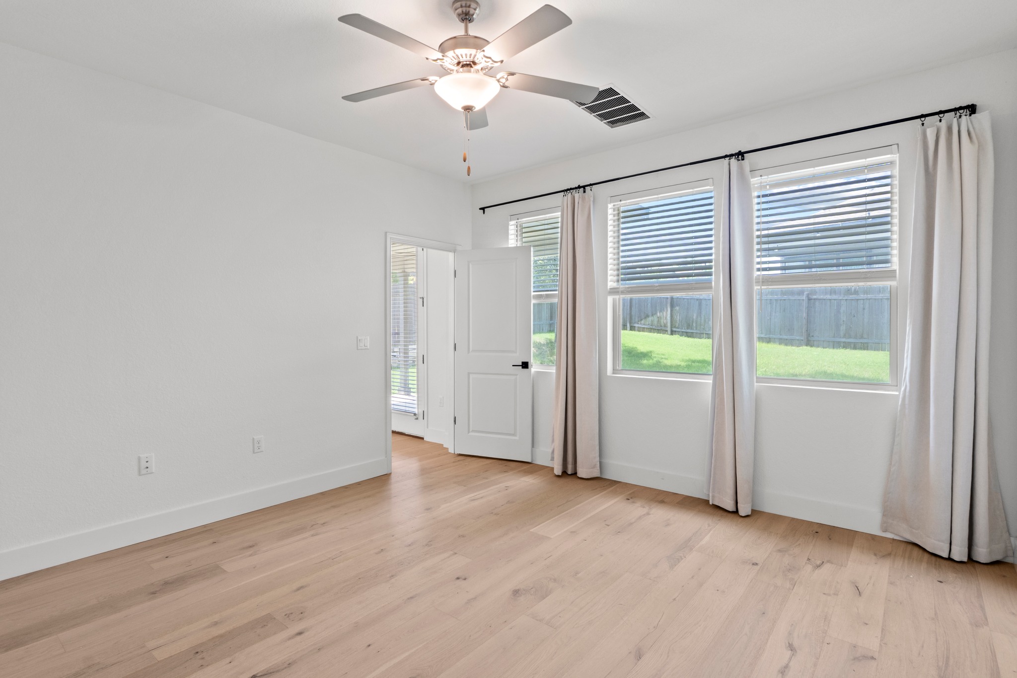 1101 Skeeter Cove Austin, TX 78748 - Photo 14 of 31 Hardwood floors and generous windows create an airy, naturally illuminated room.