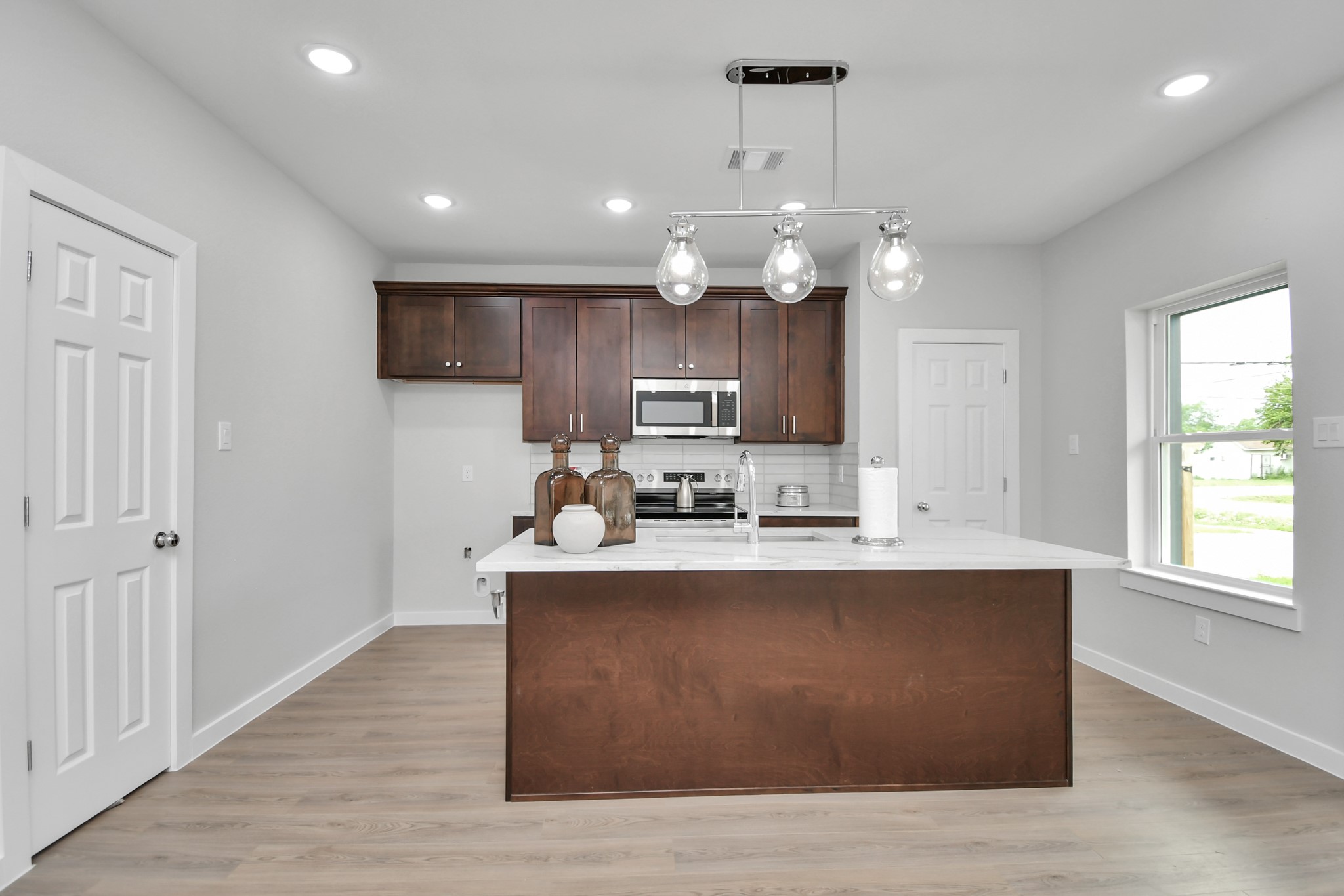 9808 Nedwald Street Houston, TX 77029 - Photo 11 of 39 a large kitchen with stainless steel appliances granite countertop a sink a stove and a refrigerator
