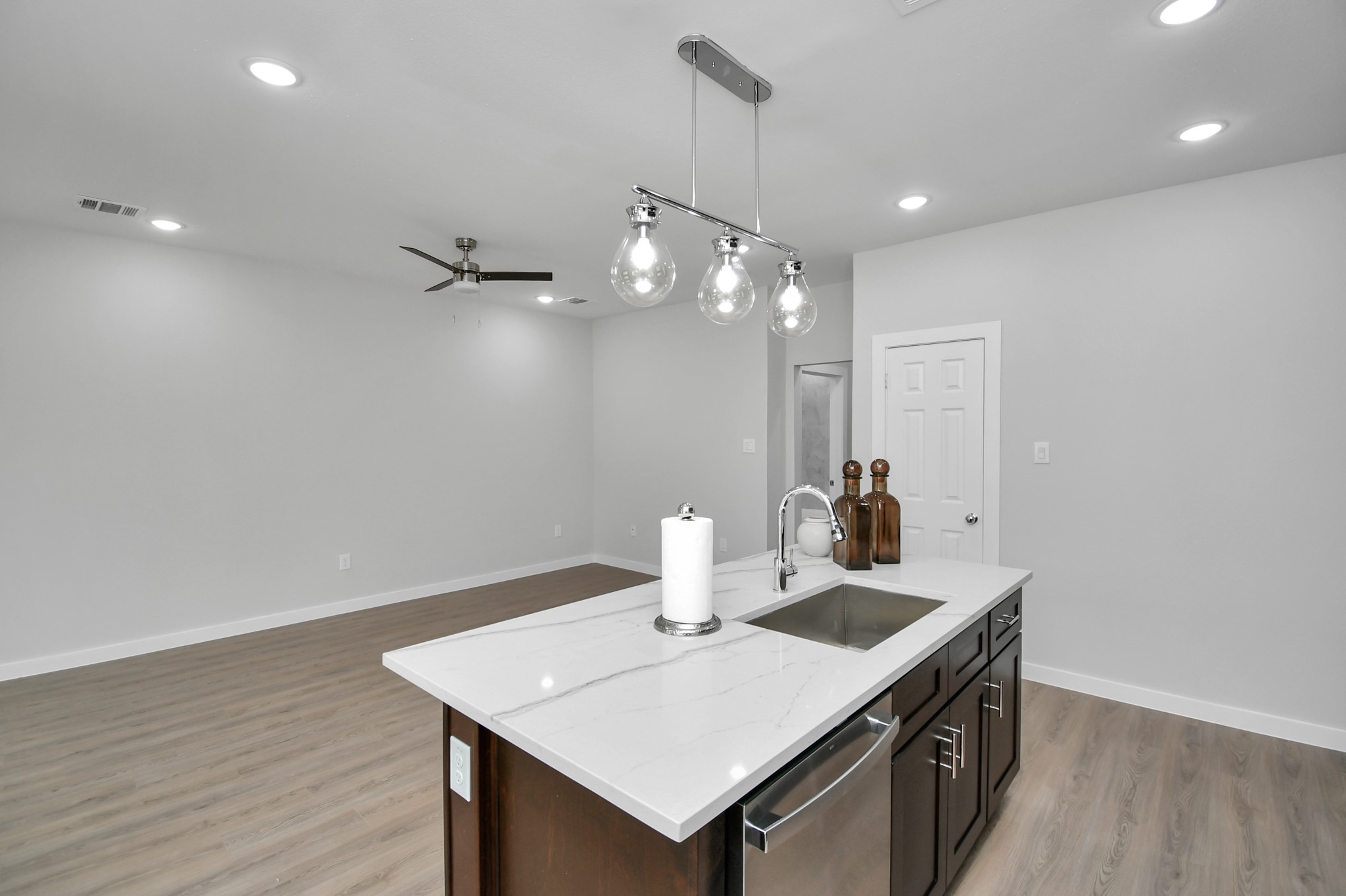 9808 Nedwald Street Houston, TX 77029 - Photo 15 of 39 a kitchen with a sink cabinets and wooden floor