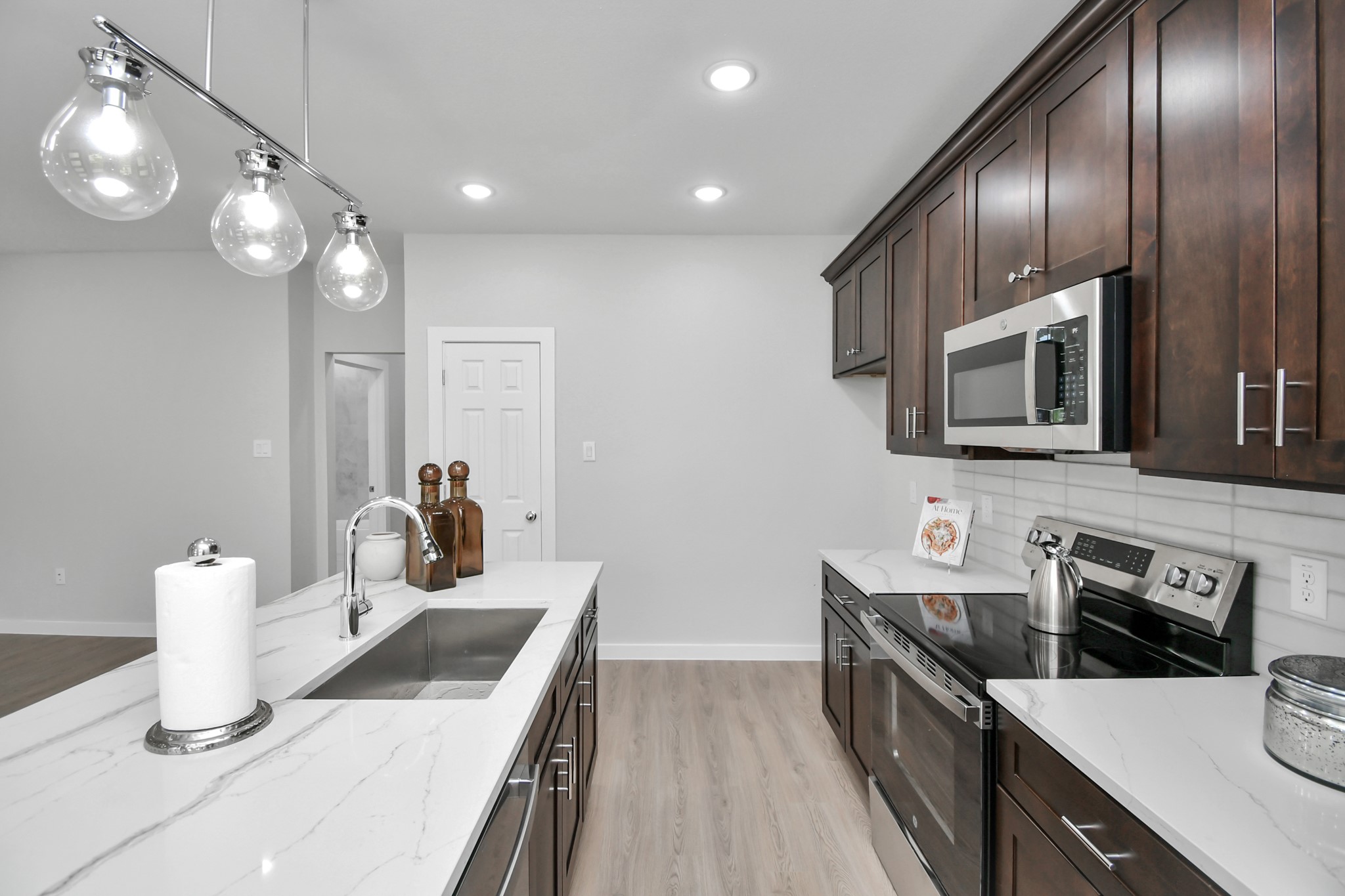 9808 Nedwald Street Houston, TX 77029 - Photo 16 of 39 a kitchen with stainless steel appliances a sink stove and microwave