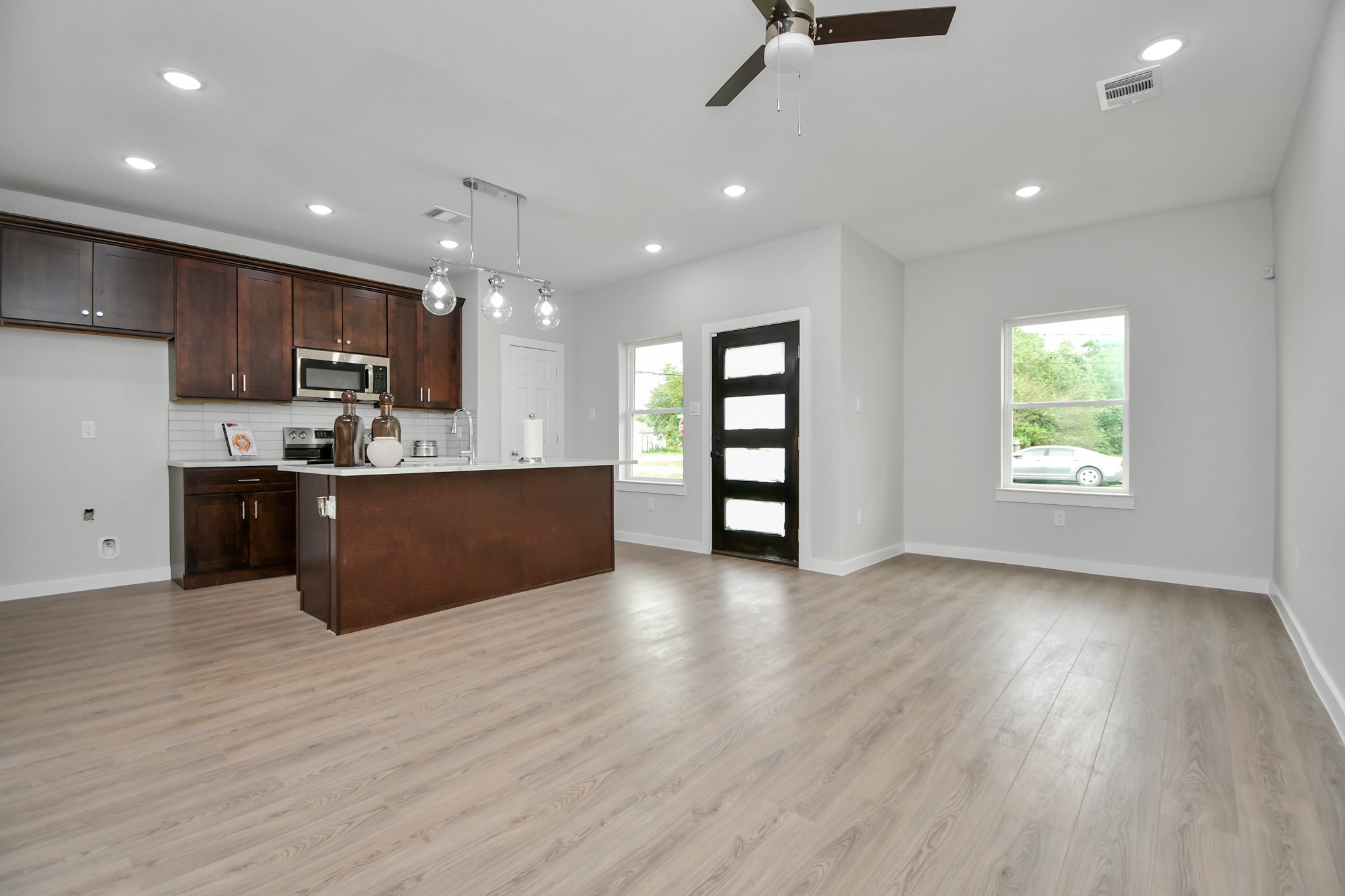 9808 Nedwald Street Houston, TX 77029 - Photo 18 of 39 a kitchen with stainless steel appliances kitchen island wooden cabinets and granite counter tops