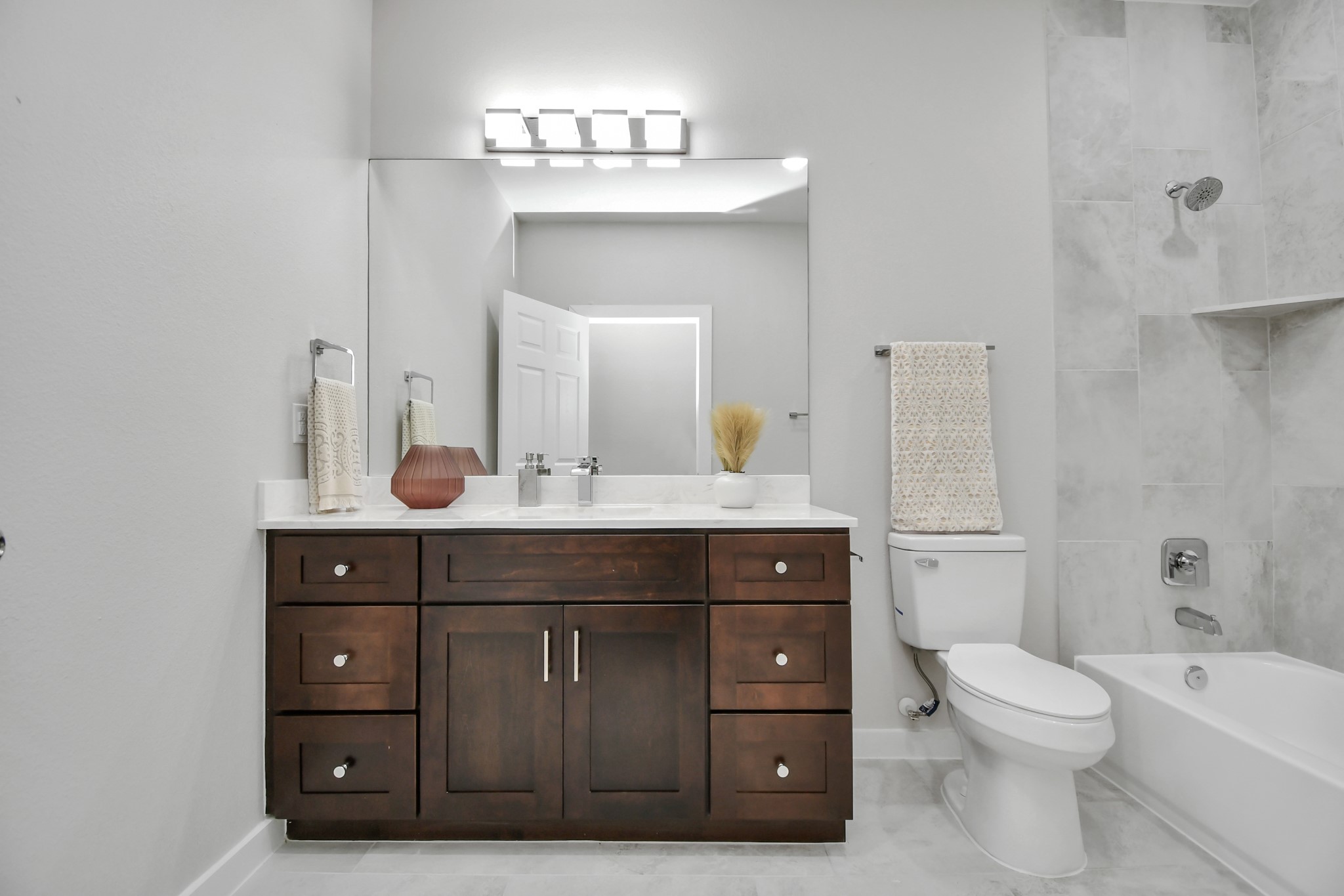 9808 Nedwald Street Houston, TX 77029 - Photo 20 of 39 a bathroom with a toilet a sink and mirror