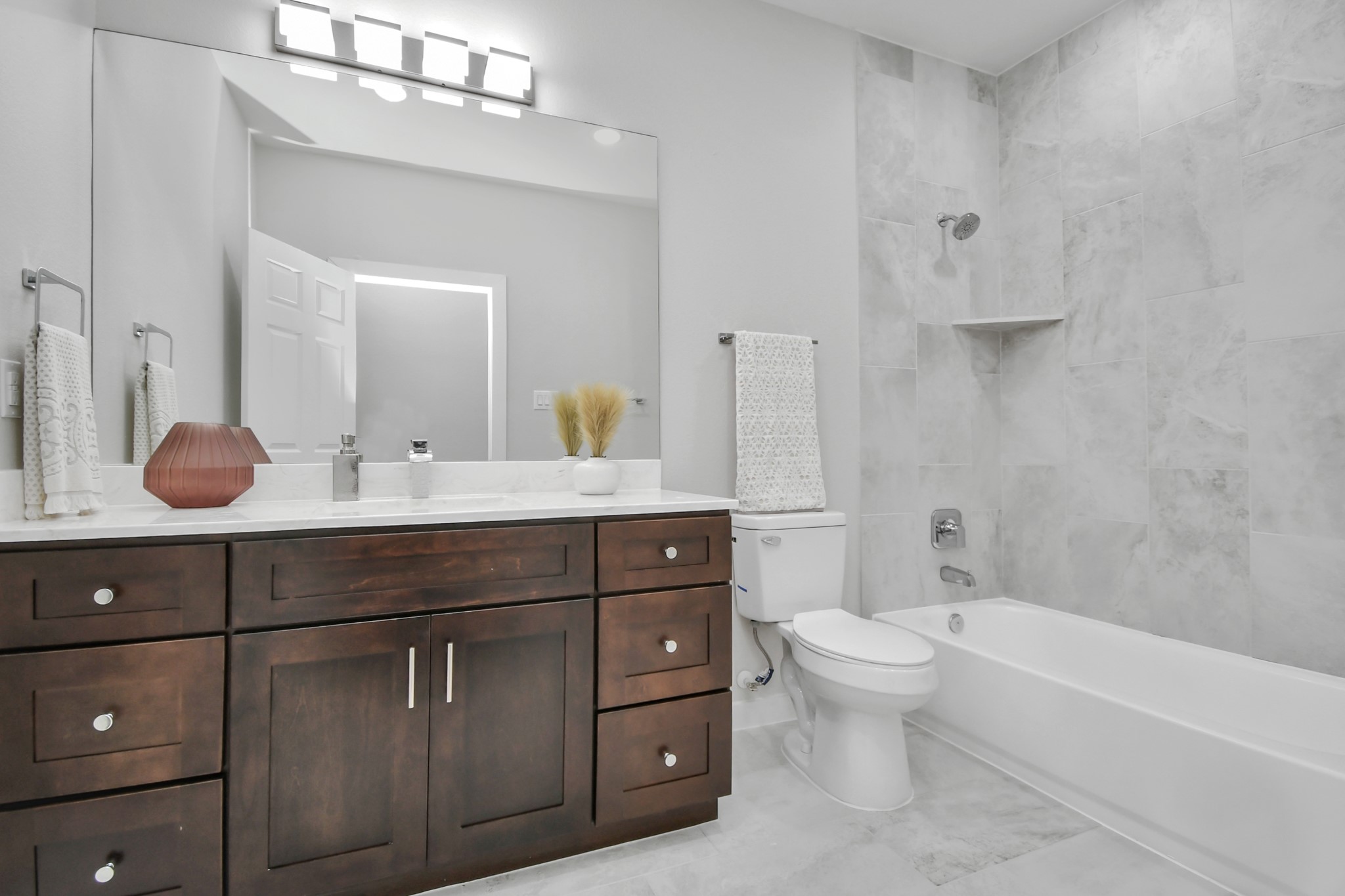 9808 Nedwald Street Houston, TX 77029 - Photo 21 of 39 a bathroom with a tub a sink double vanity and mirror
