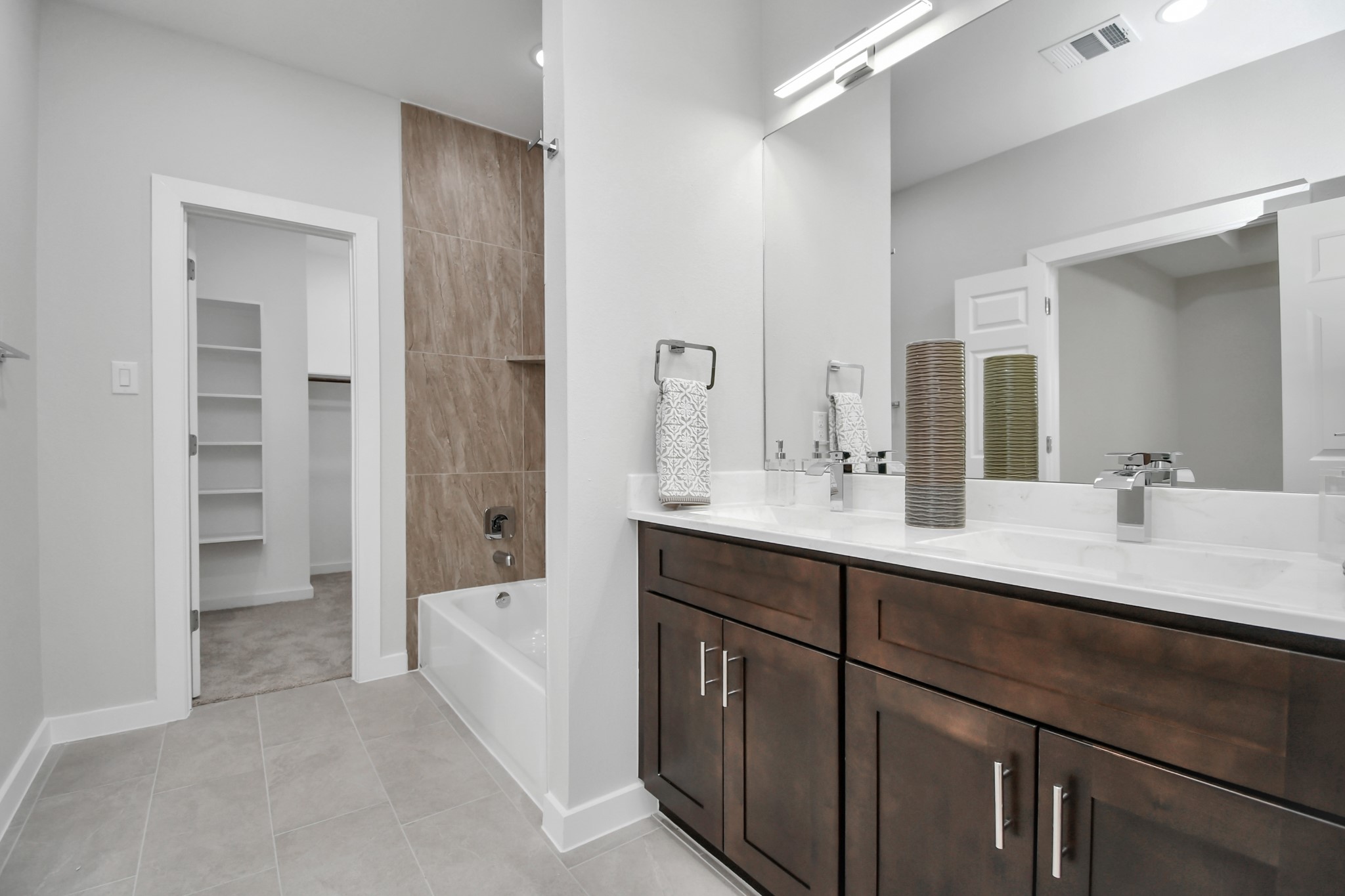9808 Nedwald Street Houston, TX 77029 - Photo 29 of 39 a spacious bathroom with a shower double sink and a mirror