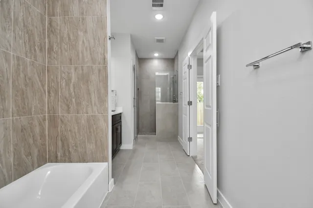 a bathroom with a double vanity sink mirror and shower