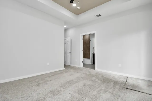 an empty room with a window and wooden floor