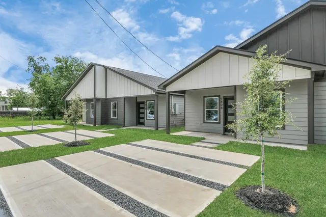 a view of a house with a yard and tree s