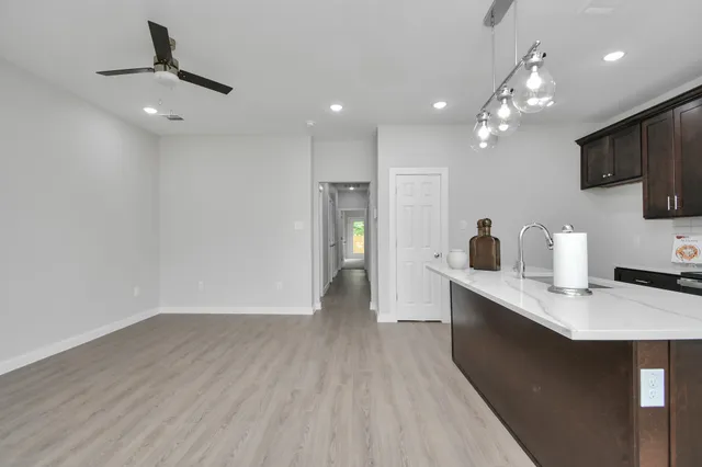 a kitchen with kitchen island a sink stainless steel appliances and cabinets