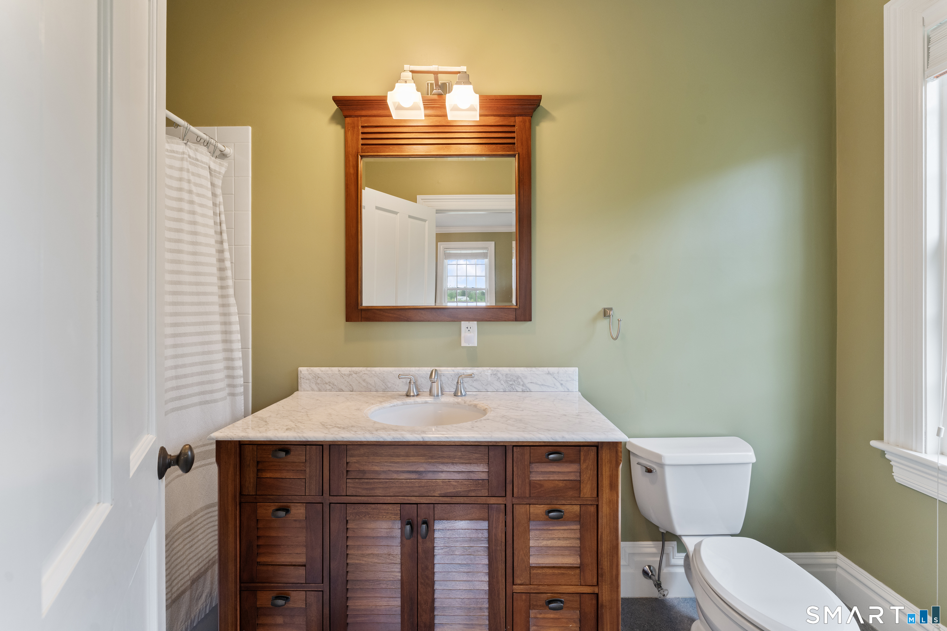155 Paine Road Woodstock, CT 06281 - Photo 28 of 40 a bathroom with a toilet a sink and mirror