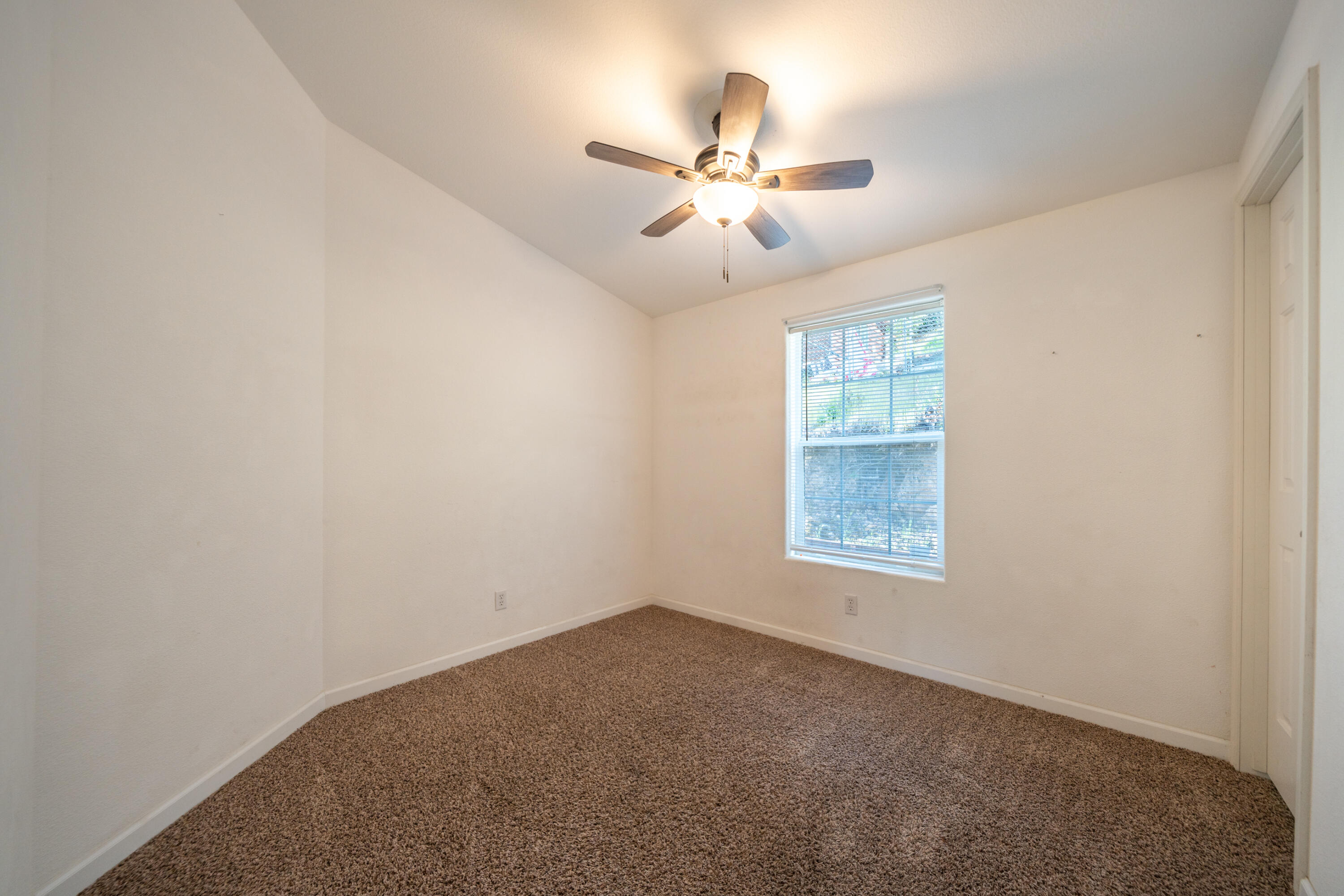 22151 Ravine Court Redding, CA 96003 - Photo 12 of 34 an empty room with windows and fan