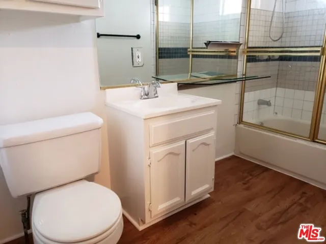 a bathroom with a toilet sink and a mirror