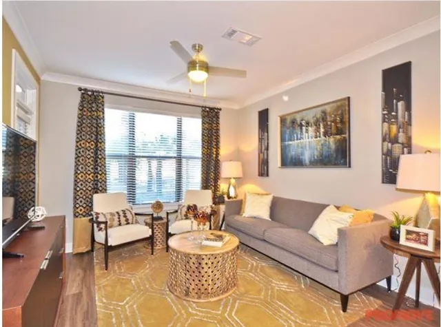 a living room with furniture and a large window