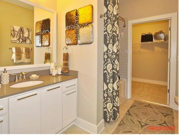 a bathroom with a granite countertop sink a mirror a shower and a shower