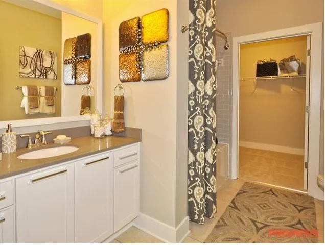 a bathroom with a granite countertop sink a mirror a shower and a shower
