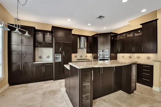 a kitchen with granite countertop stainless steel appliances and wooden cabinets